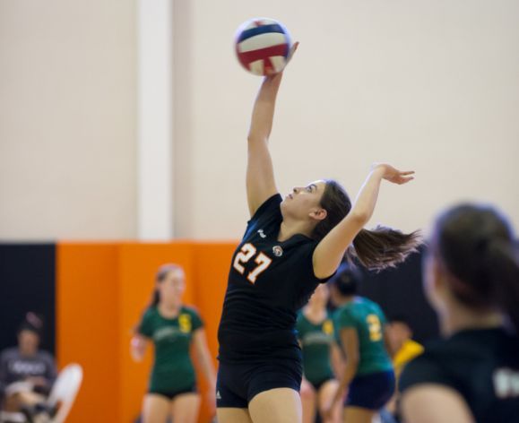 student playing volleyball