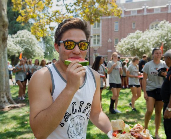 Student eating watermelon at picnic