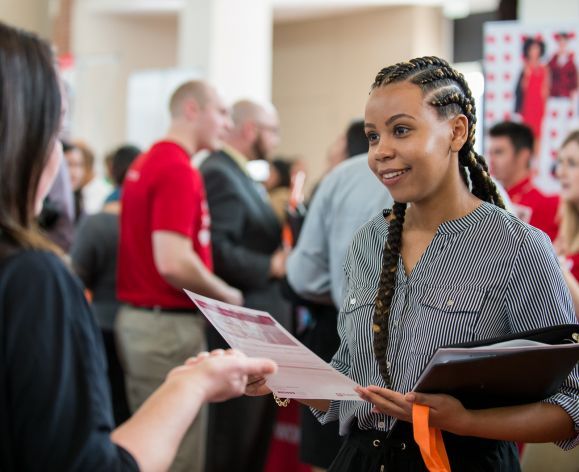 Student getting flyer at career fair