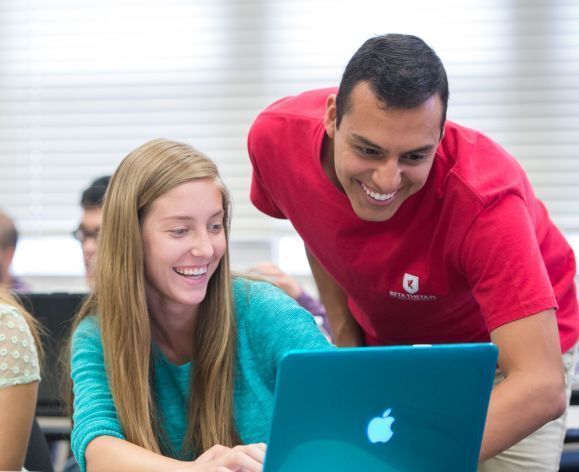 two students looking at a computer