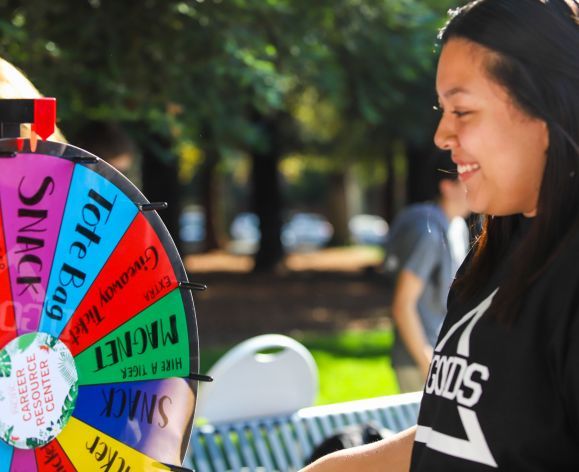 Student spinning prize wheel