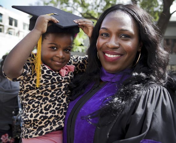 McGeorge graduate holding child