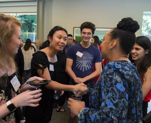 students shaking hands at event