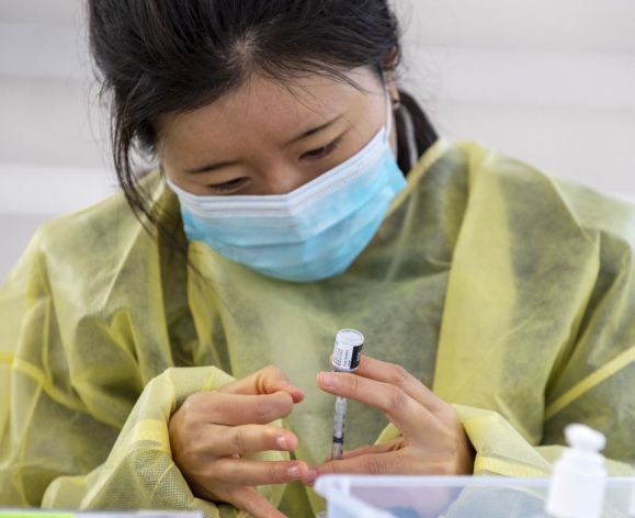 Medical professional prepping vaccine