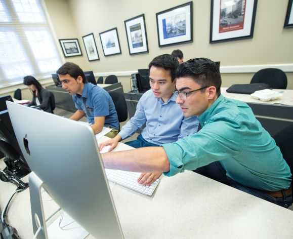 Business students collaborate in the classroom.