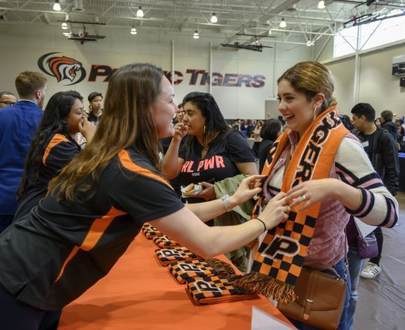 staff member giving a student a scarf