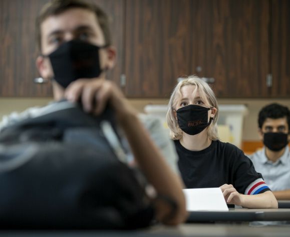 Three students wearing masks