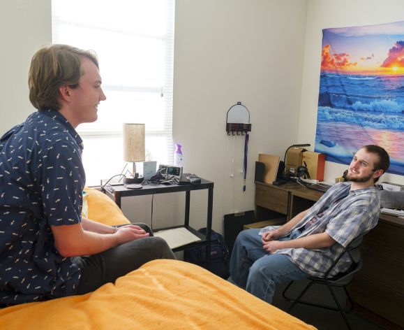 students talking in dorm