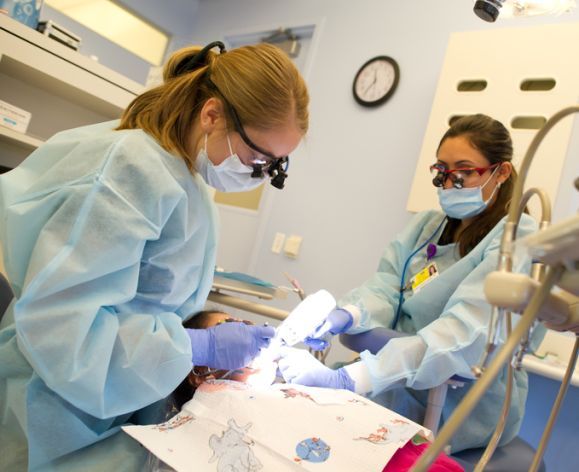 dental students working on a patient