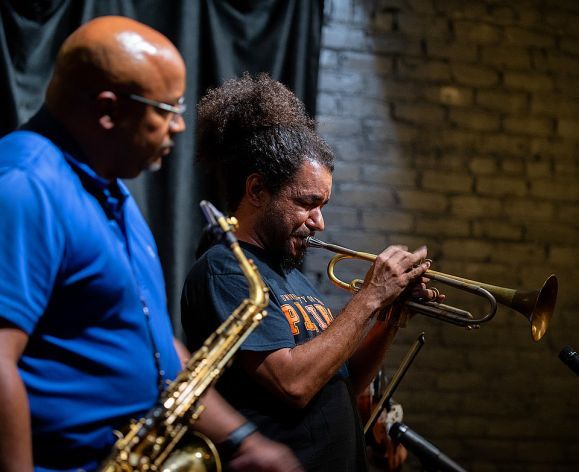 People playing trumpet and and saxophone