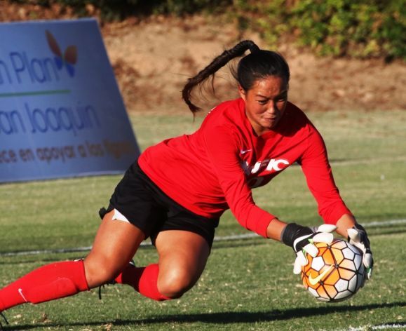 soccer goalie diving for ball