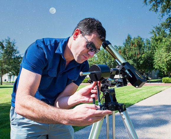 Professor Hutter looking through a telescope
