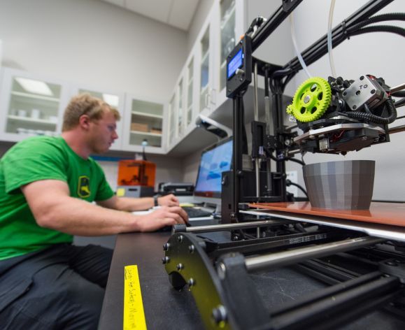 student with a 3d printer