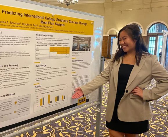 English major Brooke Tran presents research  on the relationship between international college students success and meal plan swipes.