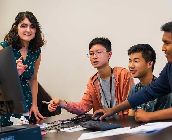 Teacher working with three students