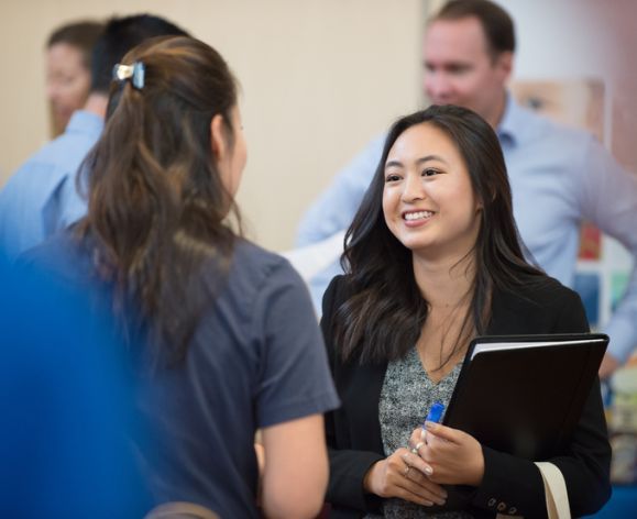 Students meet with future employers at the Eberhardt School of Business career fair.