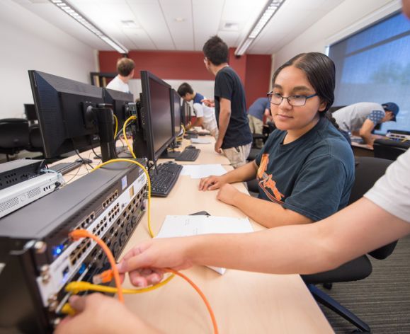 Cybersecurity student works on a computer in the lab