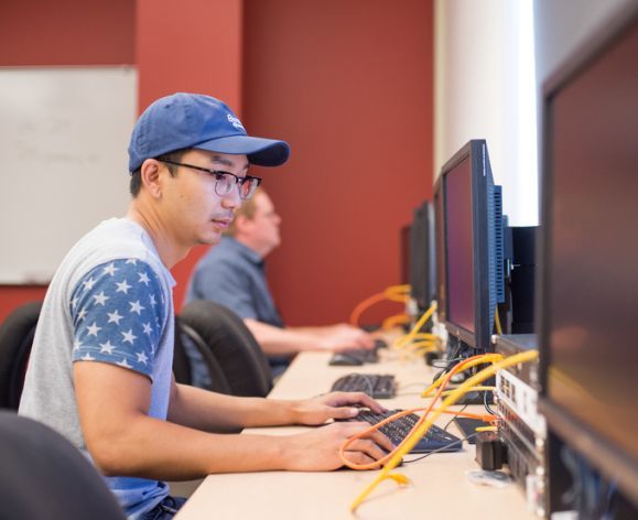 Student works on computer in Cybersecurity class