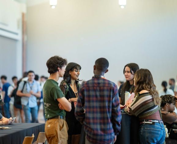 a group of Pacific students talking during orientation
