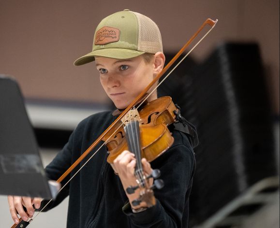 A violin student playing