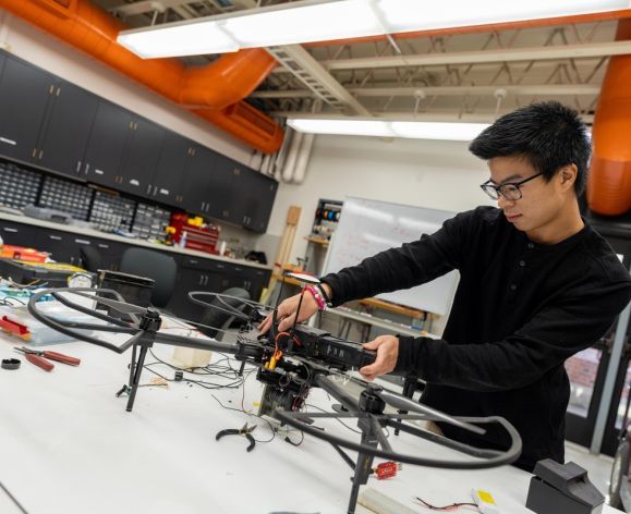 Pacific computer engineering student working on a drone
