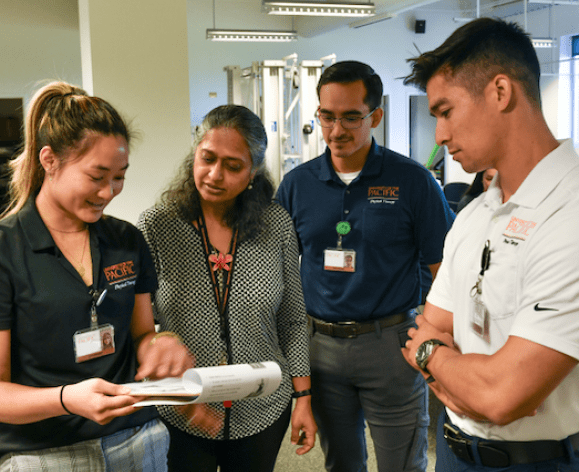 PT Professor with three students.
