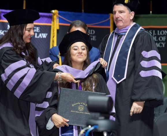 a Dugoni student receiving her diploma and hood
