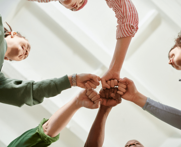 Photo by Julia M Cameron: https://www.pexels.com/photo/people-in-circle-formation-doing-fist-bump-6995402/