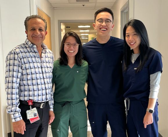 Three pharmacy fellows with a physician at a hospital site