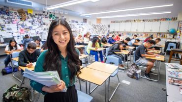 Teaching student in a high school classroom