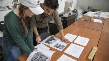 students looking at drafts of papers and essays