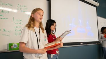 students looking at drafts of papers and essays