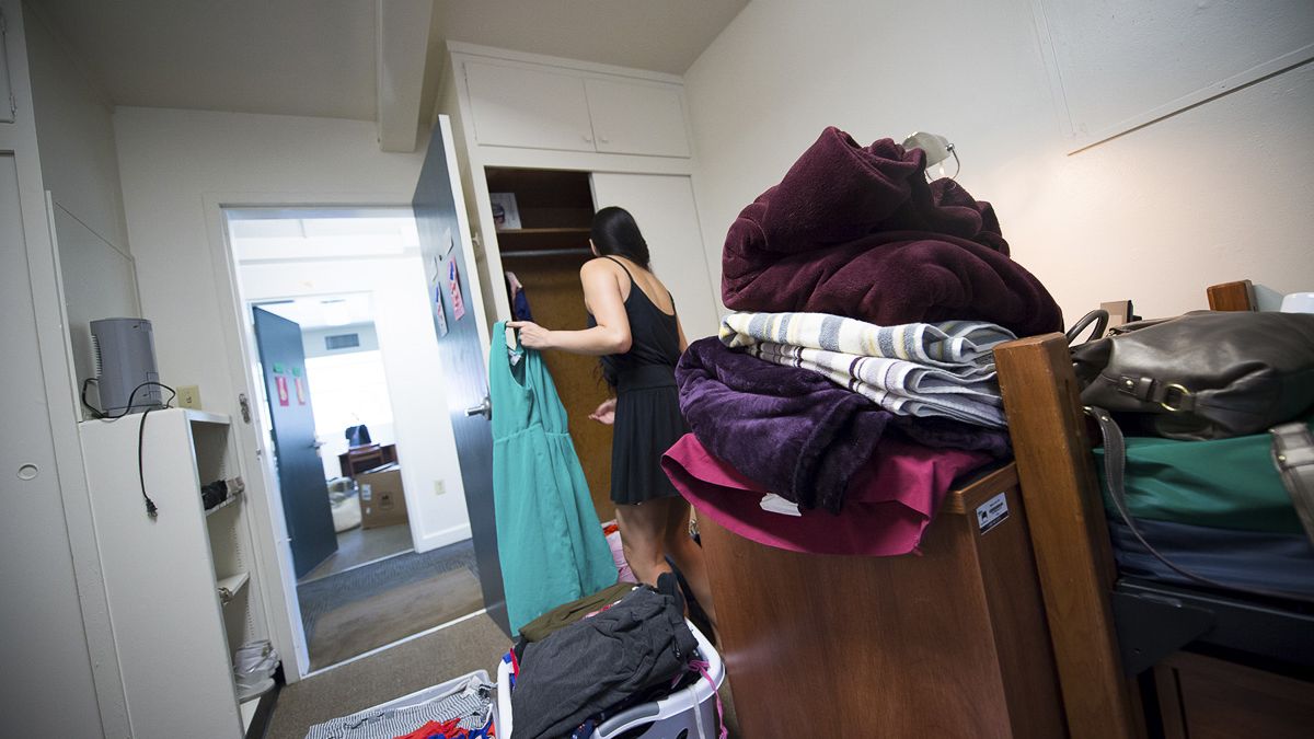 a student puts away her freshly laundered clothes