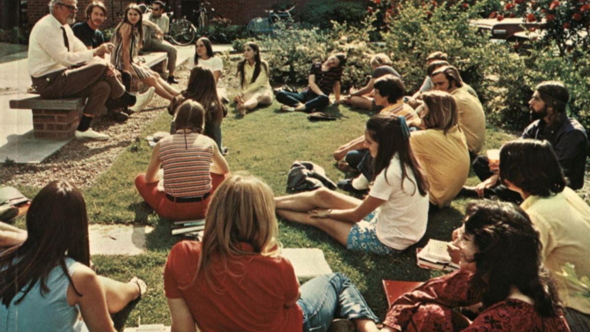 a professor reaches a class on a lawn in the 1970s