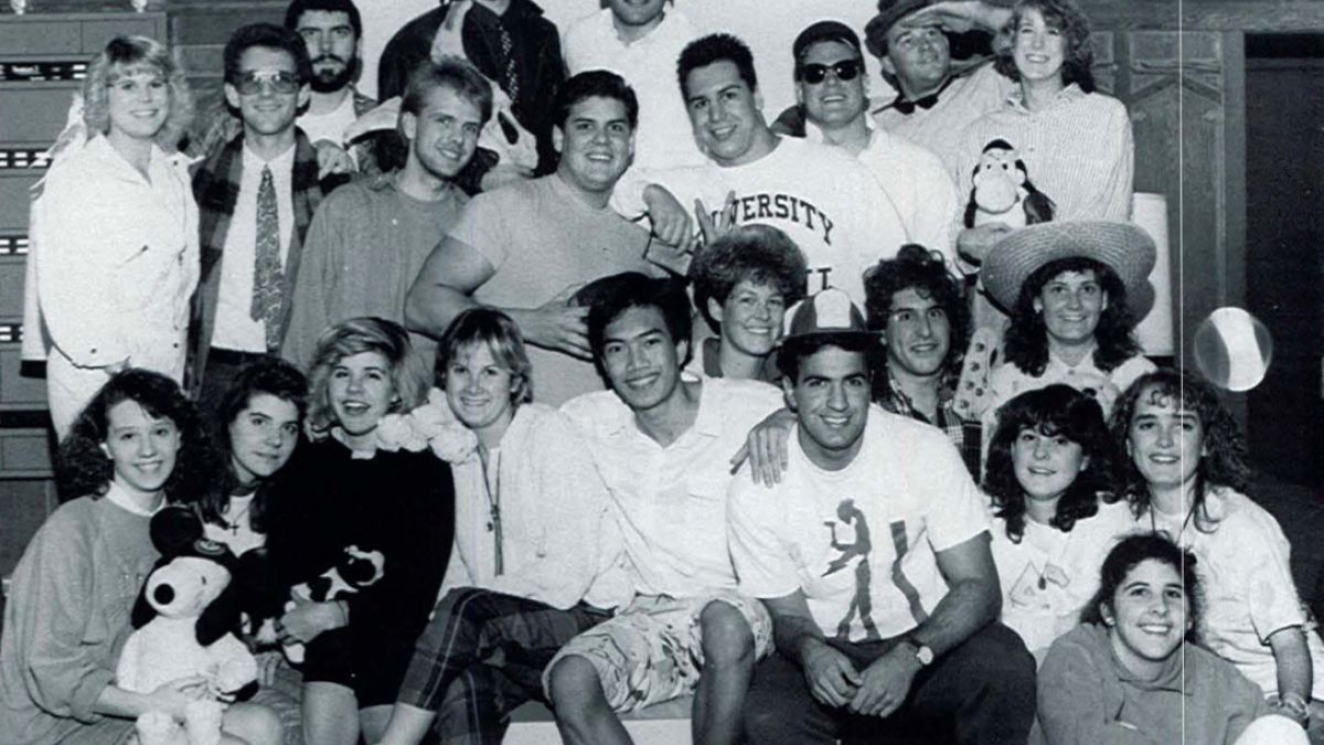 A large group of students poses together in Southwest Hall. 