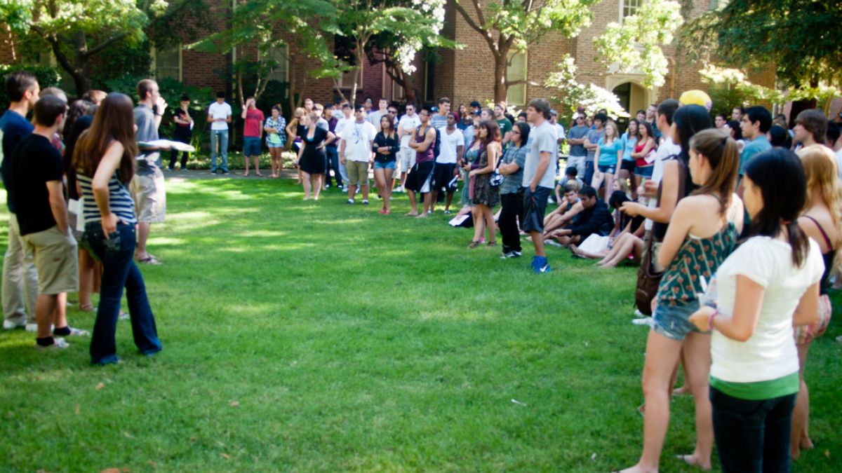 Students gather on the lawn outside Southwest Hall during orientation. 