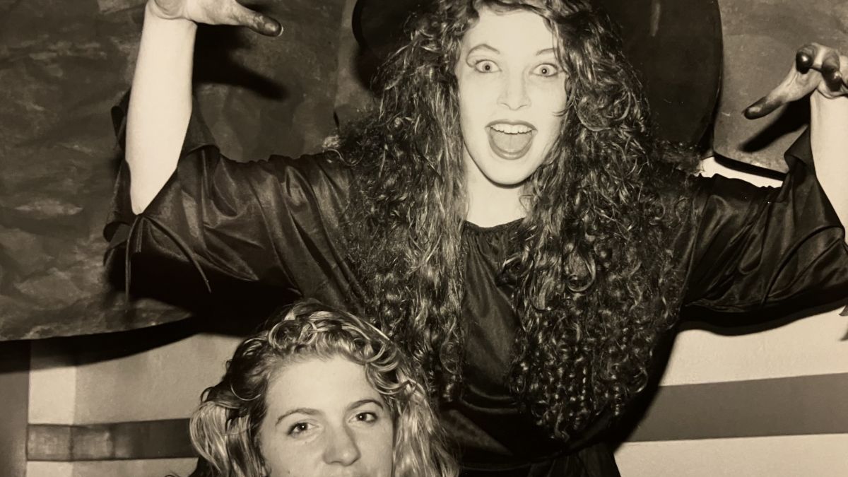 A student dressed as a witch poses for the camera. 
