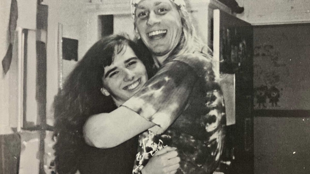 A couple hugs each other.