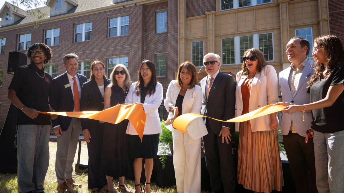 University and state leader cut an orange ribbon outside of Southwest Hall